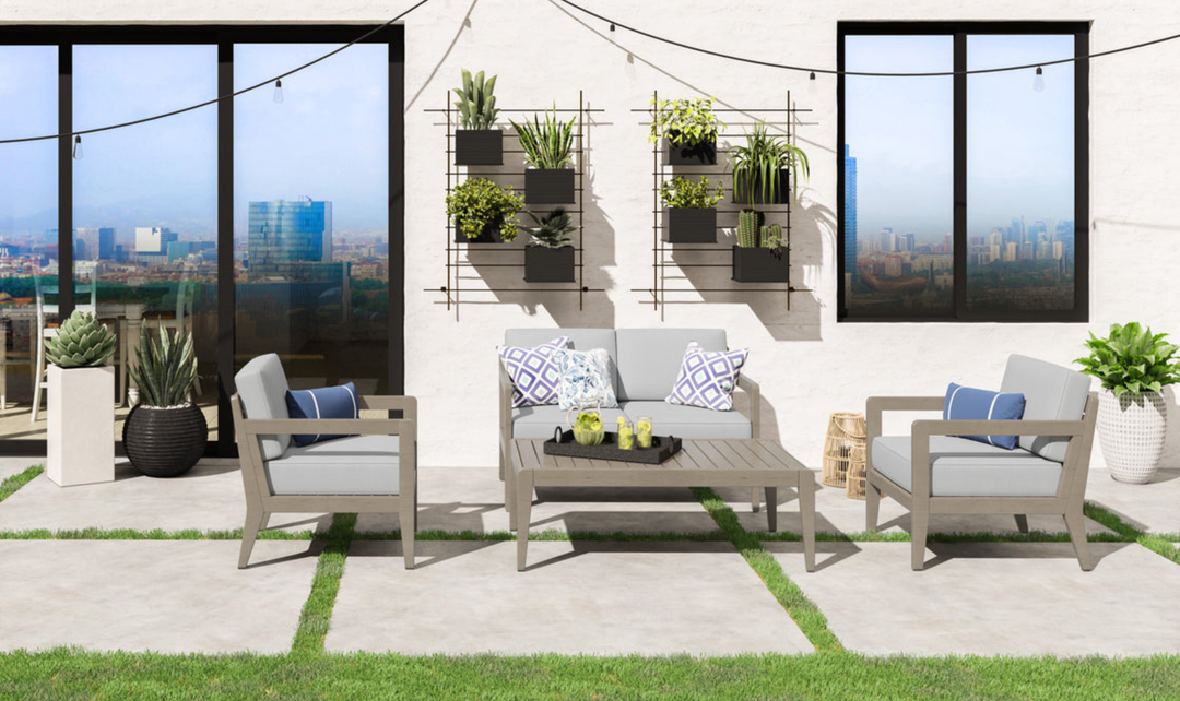 Outdoor seating cluster with matching rectangular coffee table on a modern paved patio.