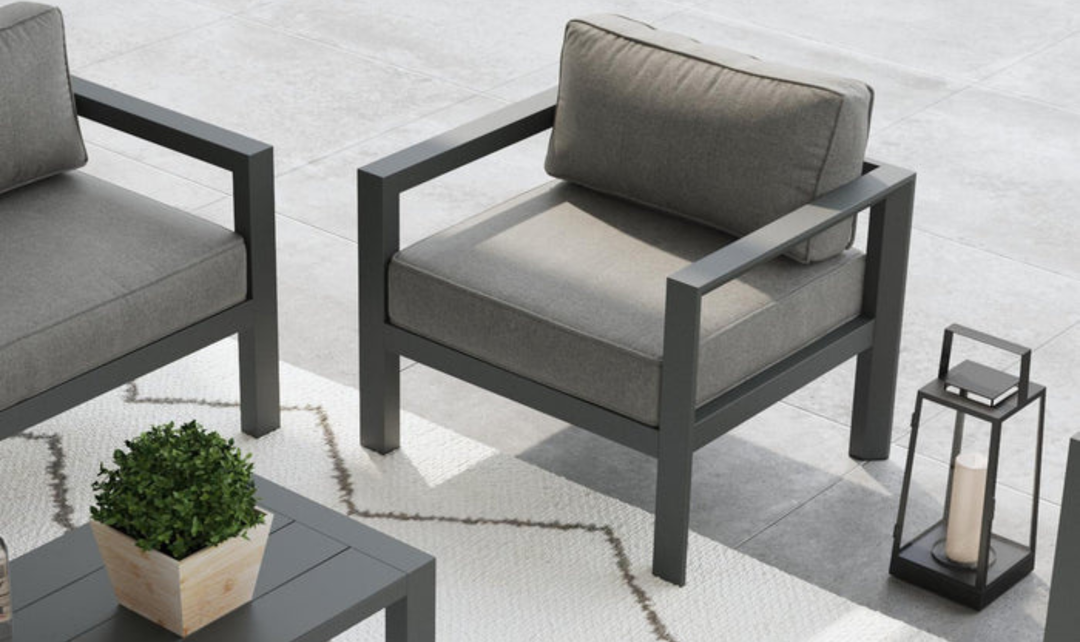 Close-up of gray upholstered chair with rectangular armrests and cushion