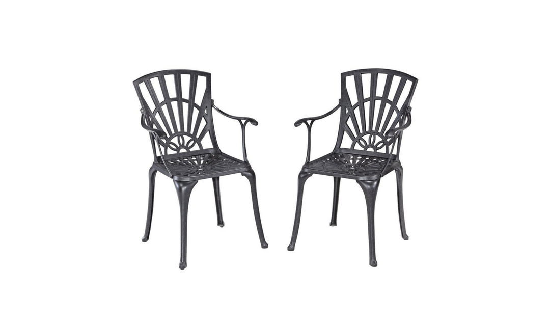 two metal patio chairs with gray cushions shown with a circular table in a modern room